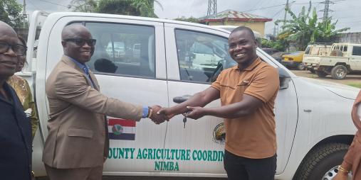 Minister Nuetah handing over the key of one of the vehicles to Nimba CAC